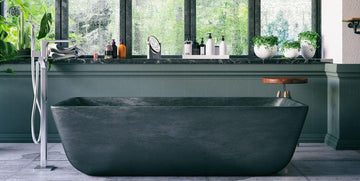 Modern freestanding bathtub in stylish bathroom with greenery and luxury decor
