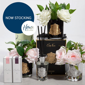 Elegant Côte Noire home fragrance collection with luxury diffusers, candles, and fresh roses for stylish Queensland interiors