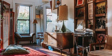 Cozy living room with vintage sideboard, framed art, and warm lighting for home decor inspiration