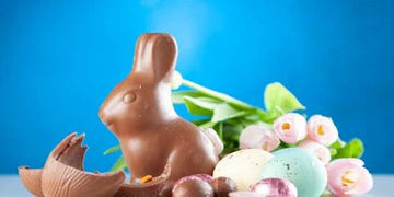 Chocolate bunny with Easter eggs and tulips for home decor