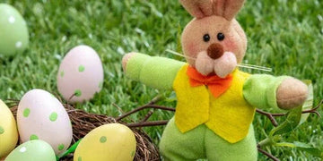 Easter bunny plush in green outfit with polka dot eggs on grass, perfect for home decor