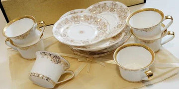 Elegant white and gold tea set with intricate patterns, perfect for luxury home decor