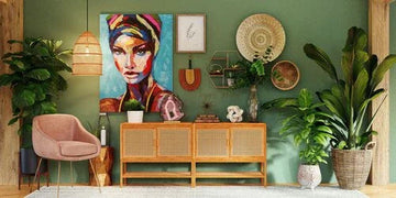 Boho chic living room with vibrant wall art, rattan sideboard, potted plants, and pink armchair for modern home decor