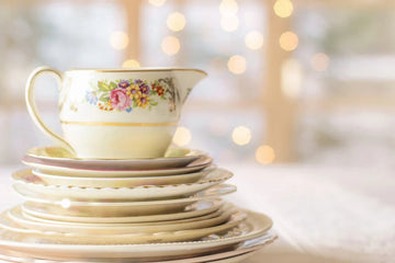 Elegant floral teacup and saucers with gold trim, perfect for vintage home decor