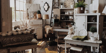 Rustic home decor with vintage furniture, clocks, and plants in a cozy, sunlit room