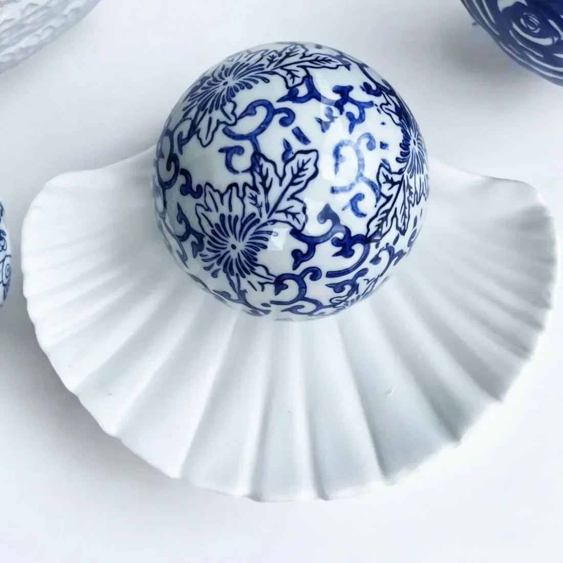 Blue and white porcelain decorative ball with floral pattern on a white ceramic shell, Exquisite Homewares