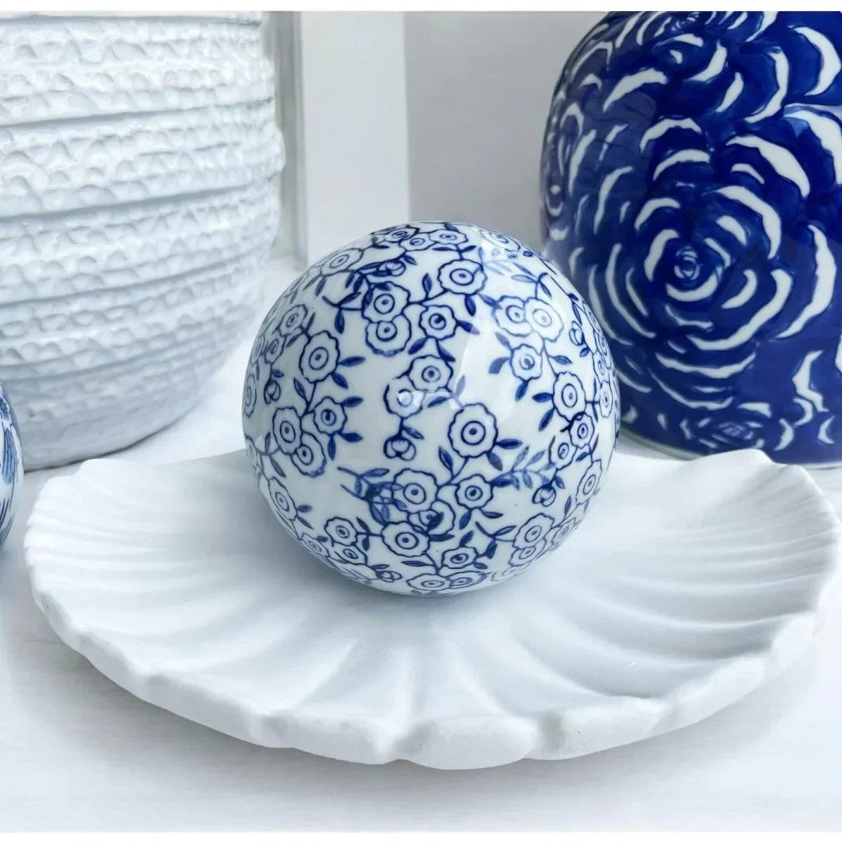 Blue and white floral porcelain decorative ball on ceramic shell plate, elegant home décor