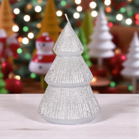 Sparkling silver Christmas tree candle with festive holiday decor background, perfect for seasonal home decoration.