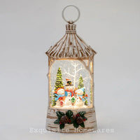 Birch-style lantern with glowing snow globe, snowmen, trees, and pinecones for festive home décor