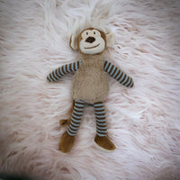 Soft plush monkey toy with striped arms and legs, perfect for nursery decor or baby gifts