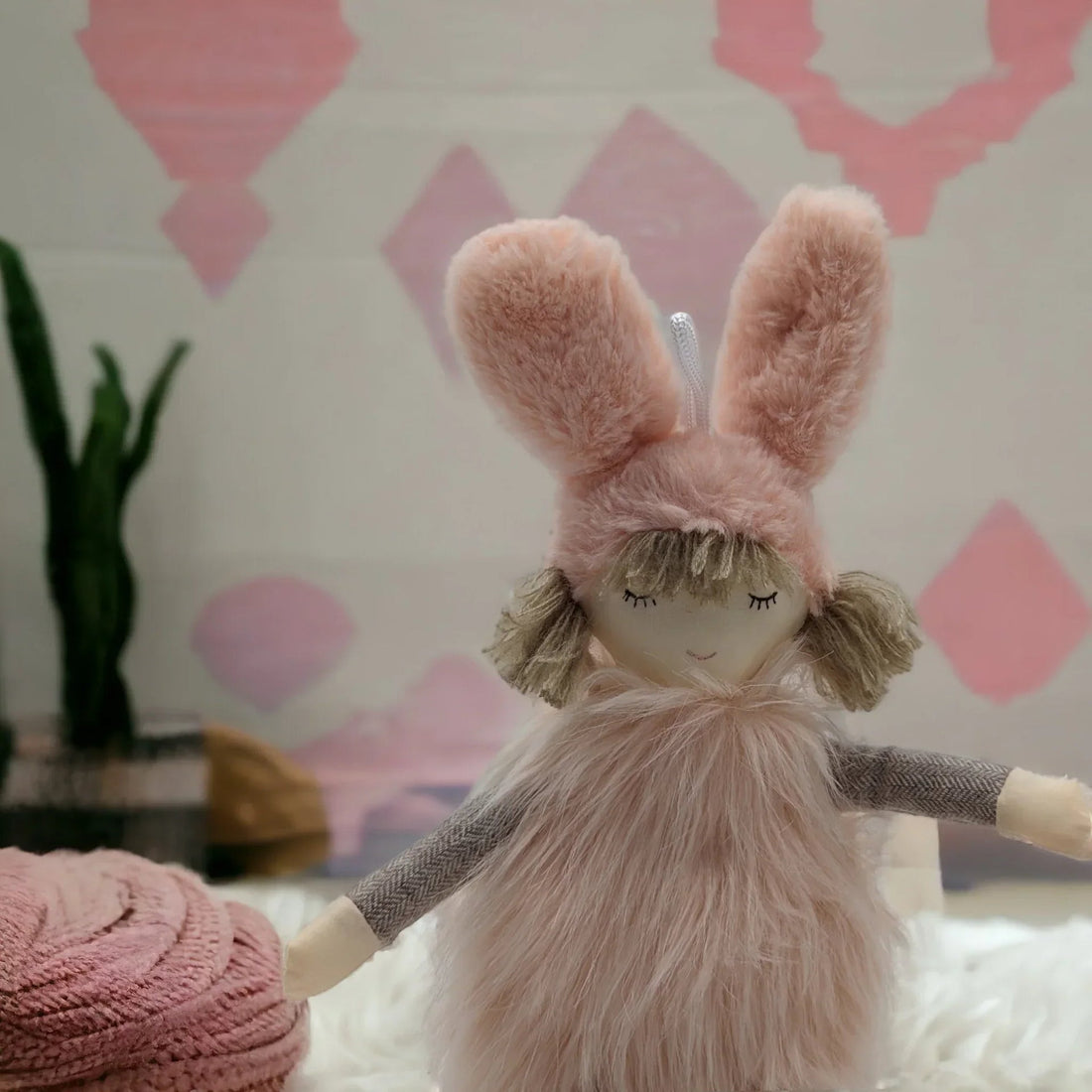 Pink plush bunny doll with fluffy ears and soft fur, perfect for nursery décor or child's room