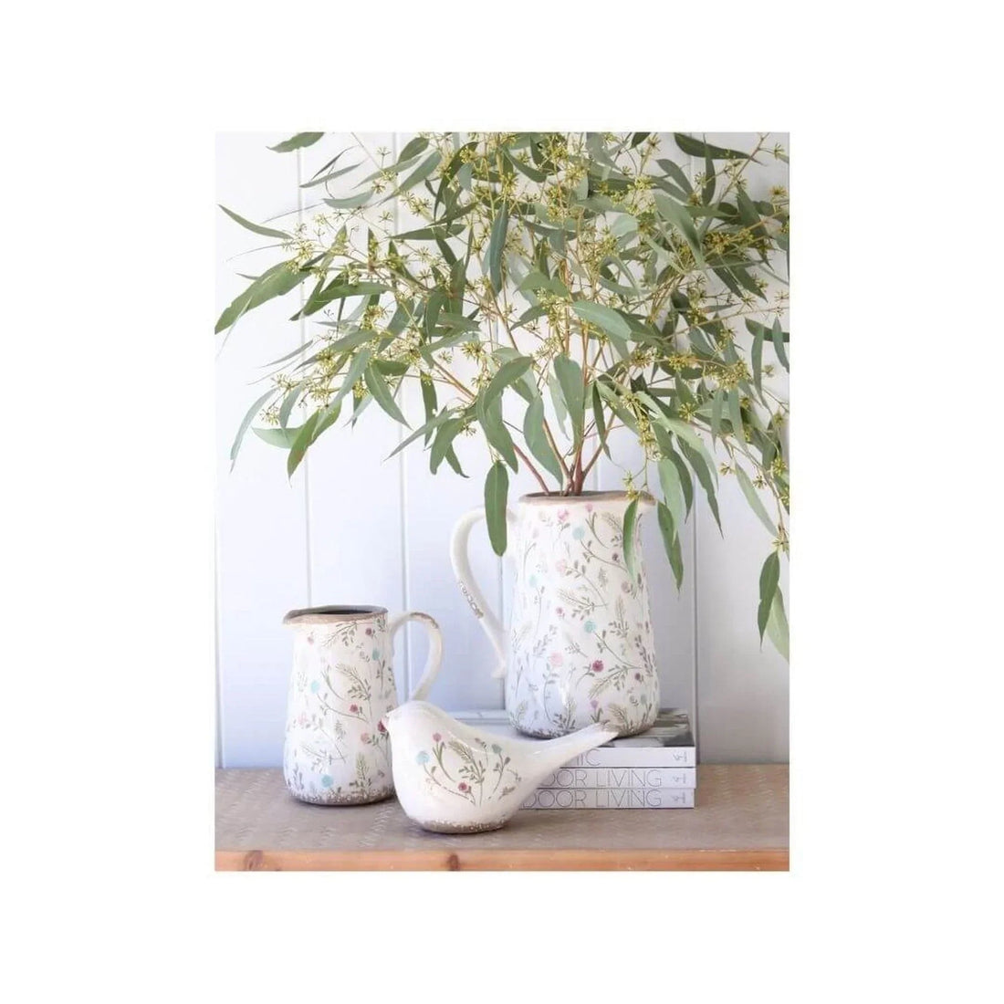 Floral ceramic pitchers and bird figurine with eucalyptus, rustic home decor accents