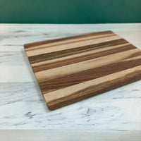 Striped wooden cutting board on marble countertop, home kitchen decor