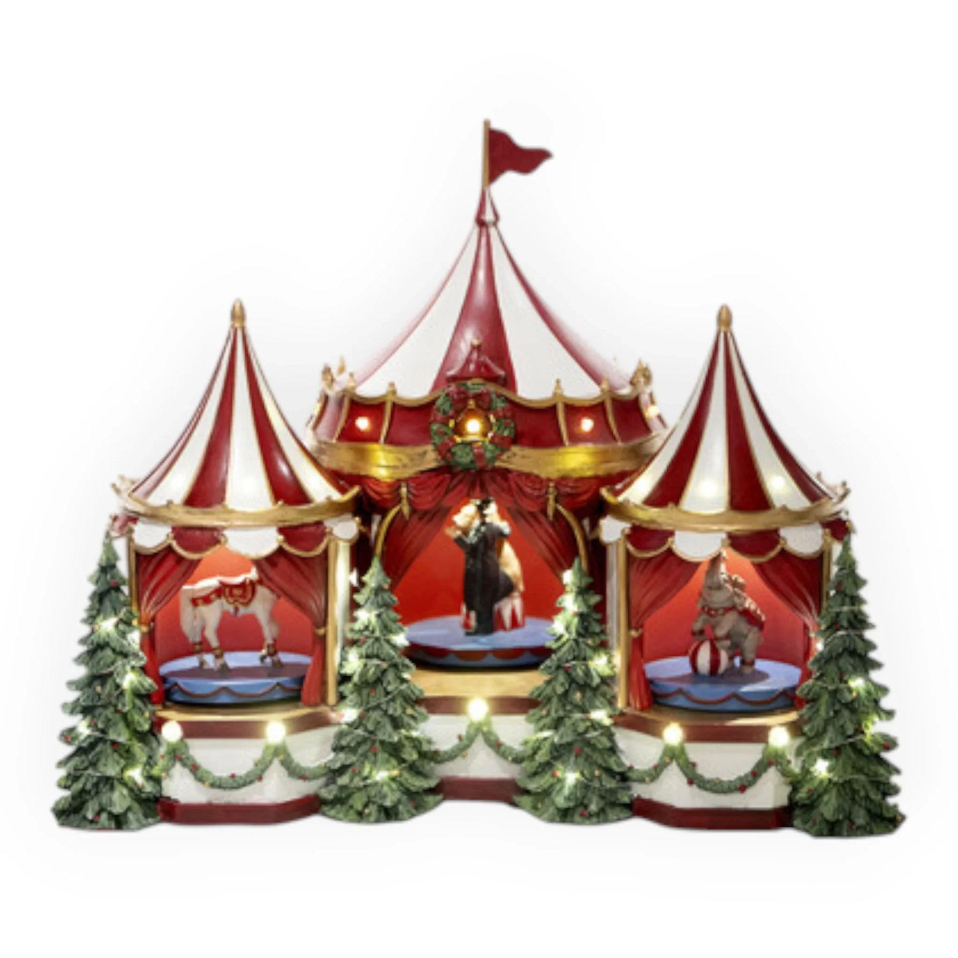Red and white striped circus tent with carousel horses, elephant, and Christmas trees, illuminated for holiday décor