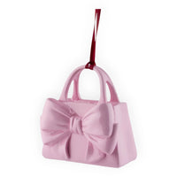 Pink handbag ornament with bow and red ribbon, perfect for home décor or gifting