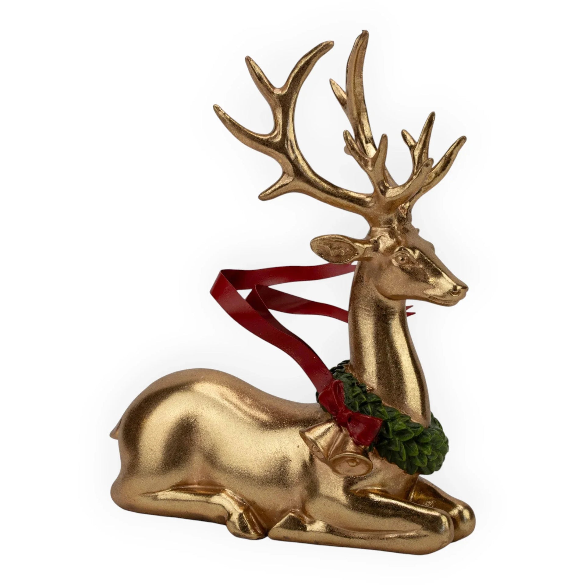 Golden lying reindeer figurine with red ribbon and green wreath, festive holiday home décor