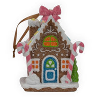 Glittery gingerbread house ornament with pink bow, candy canes, and festive windows for Christmas décor
