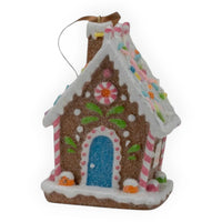 Gingerbread house ornament with candy decorations, blue door, and snow accents for Christmas décor