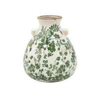White ceramic vase with green floral vine pattern, vintage-style home decor accent piece