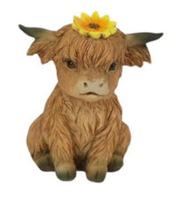 Cute Highland cow figurine with yellow flower, rustic home décor accent piece
