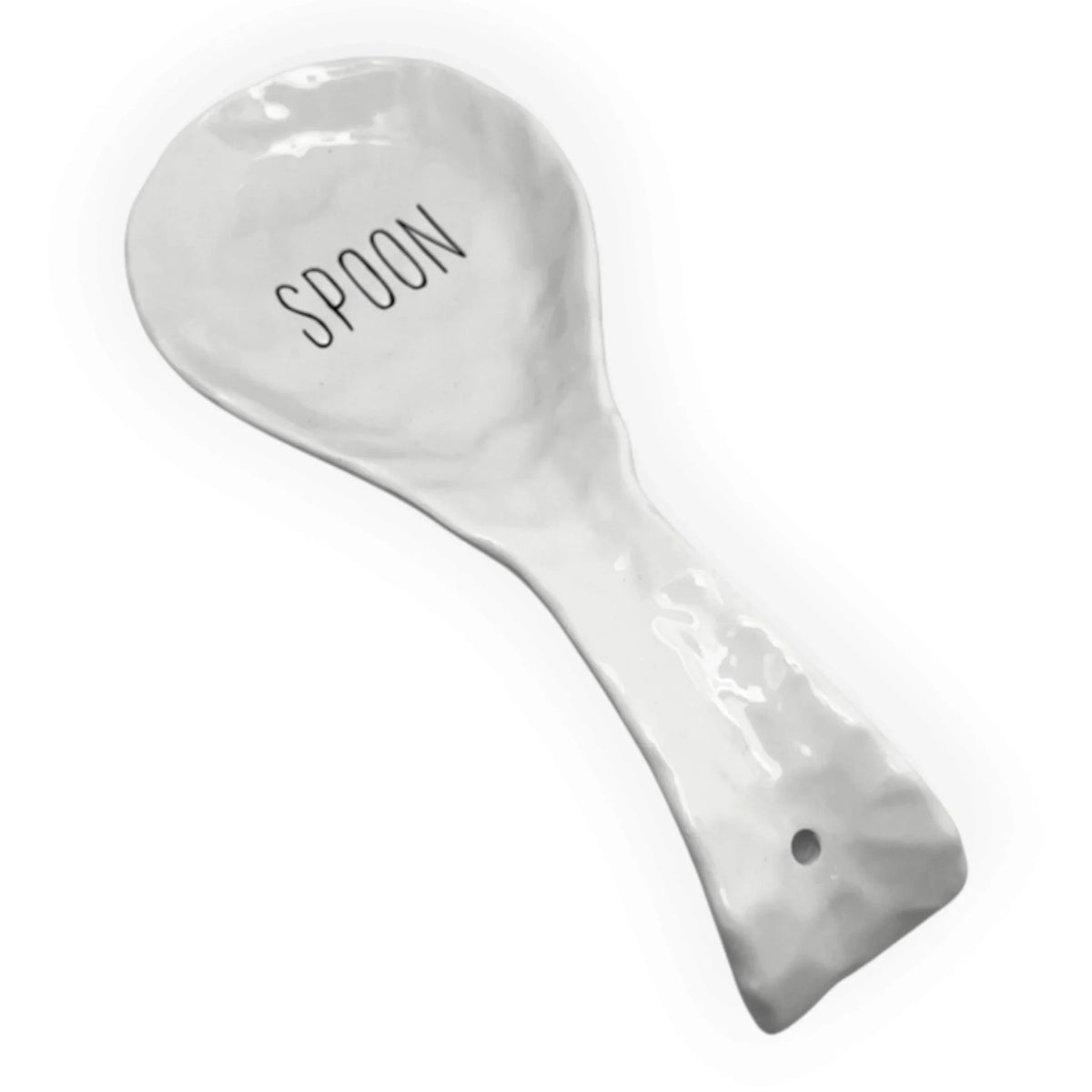 A white ceramic spoon rest with a textured, hammered finish, featuring the word 'SPOON' printed in black on the bowl and a small hole near the handle end.