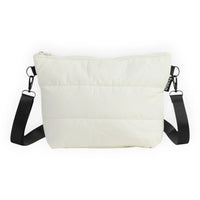 Cream quilted crossbody bag with black strap, minimalist design for everyday use