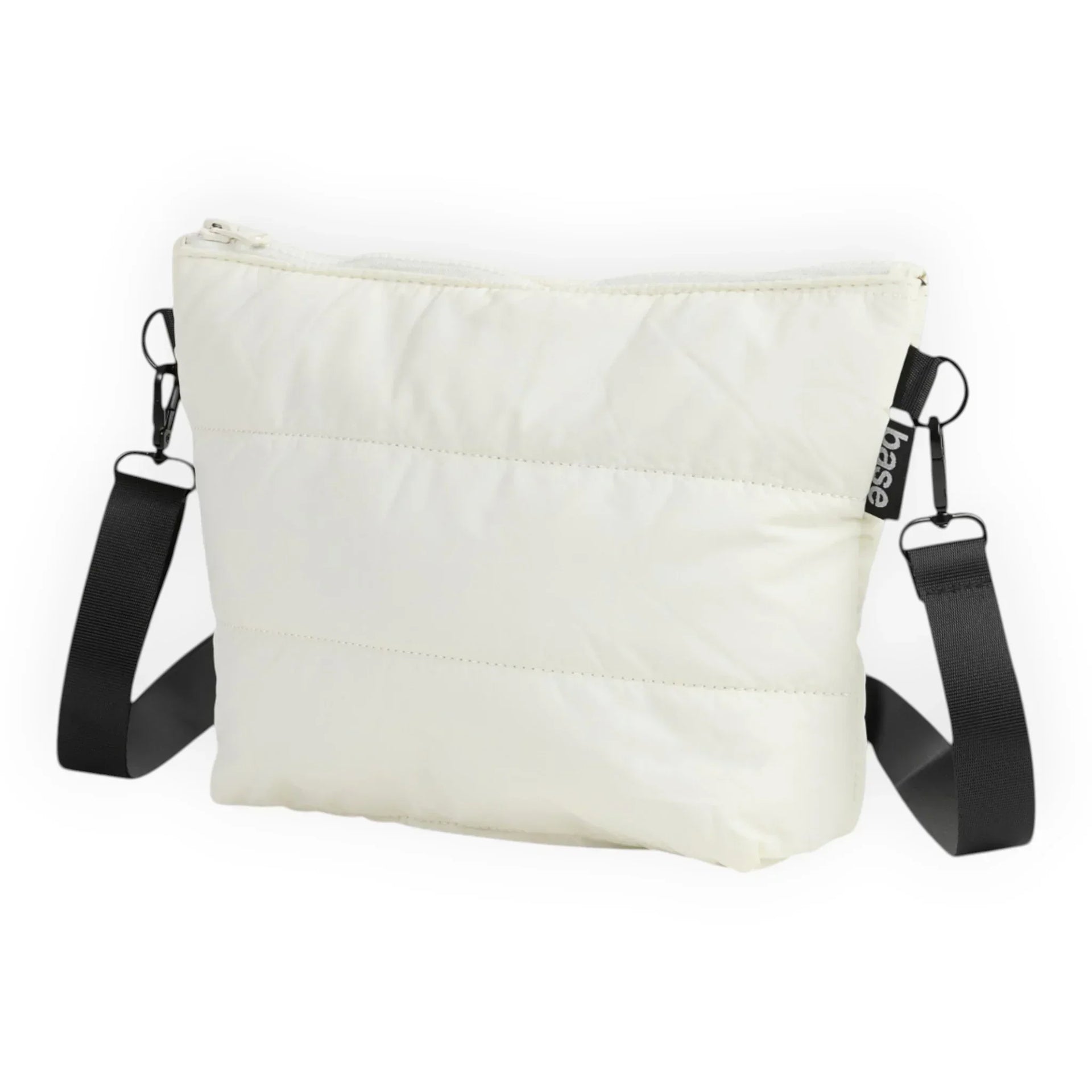 Cream quilted crossbody bag with black strap and base tag, minimalist design for everyday use