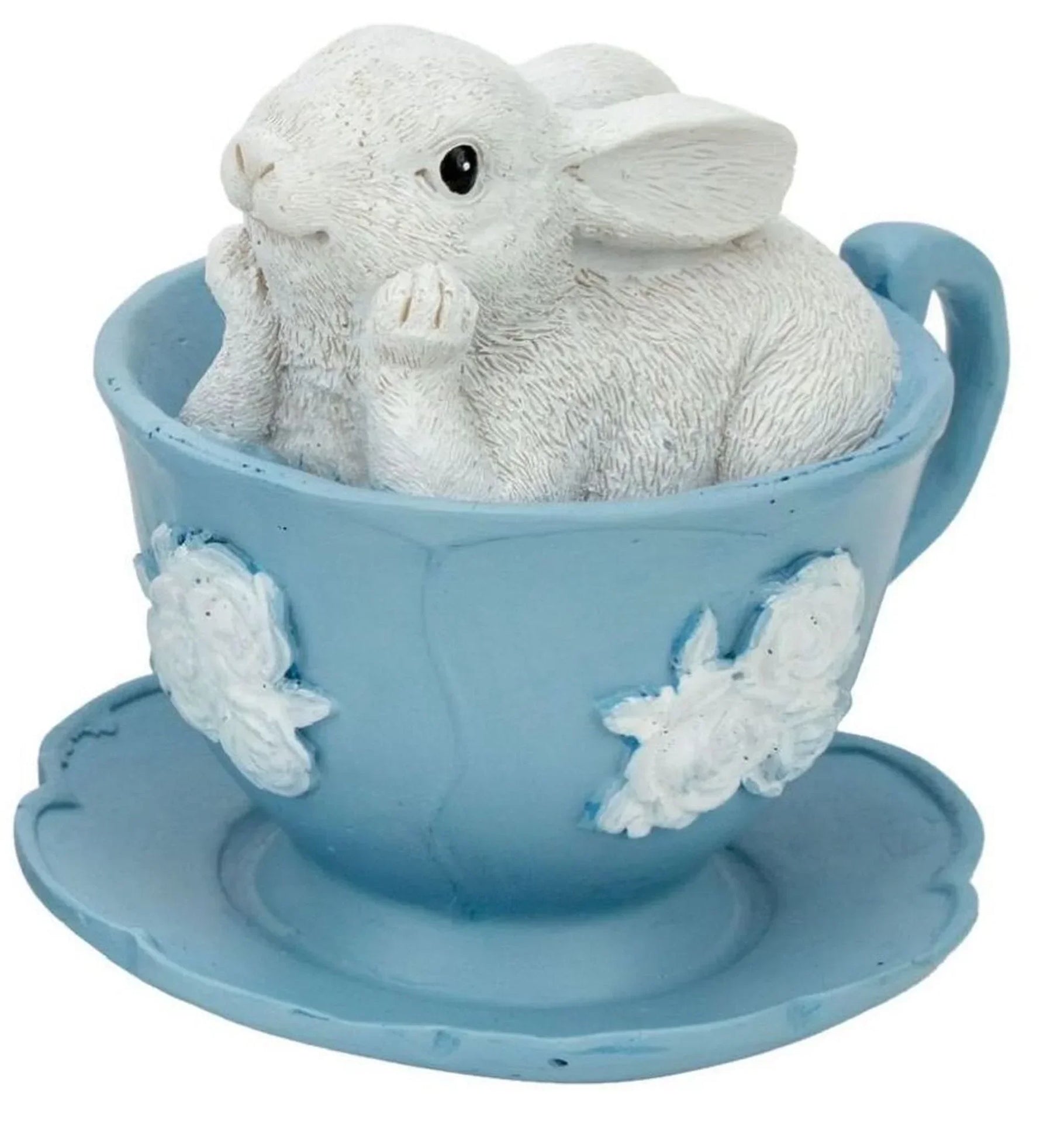 White bunny figurine nestled in a light blue teacup with floral details, charming home décor accent