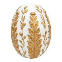 White decorative egg with gold leaf and floral detailing, elegant home décor accent piece