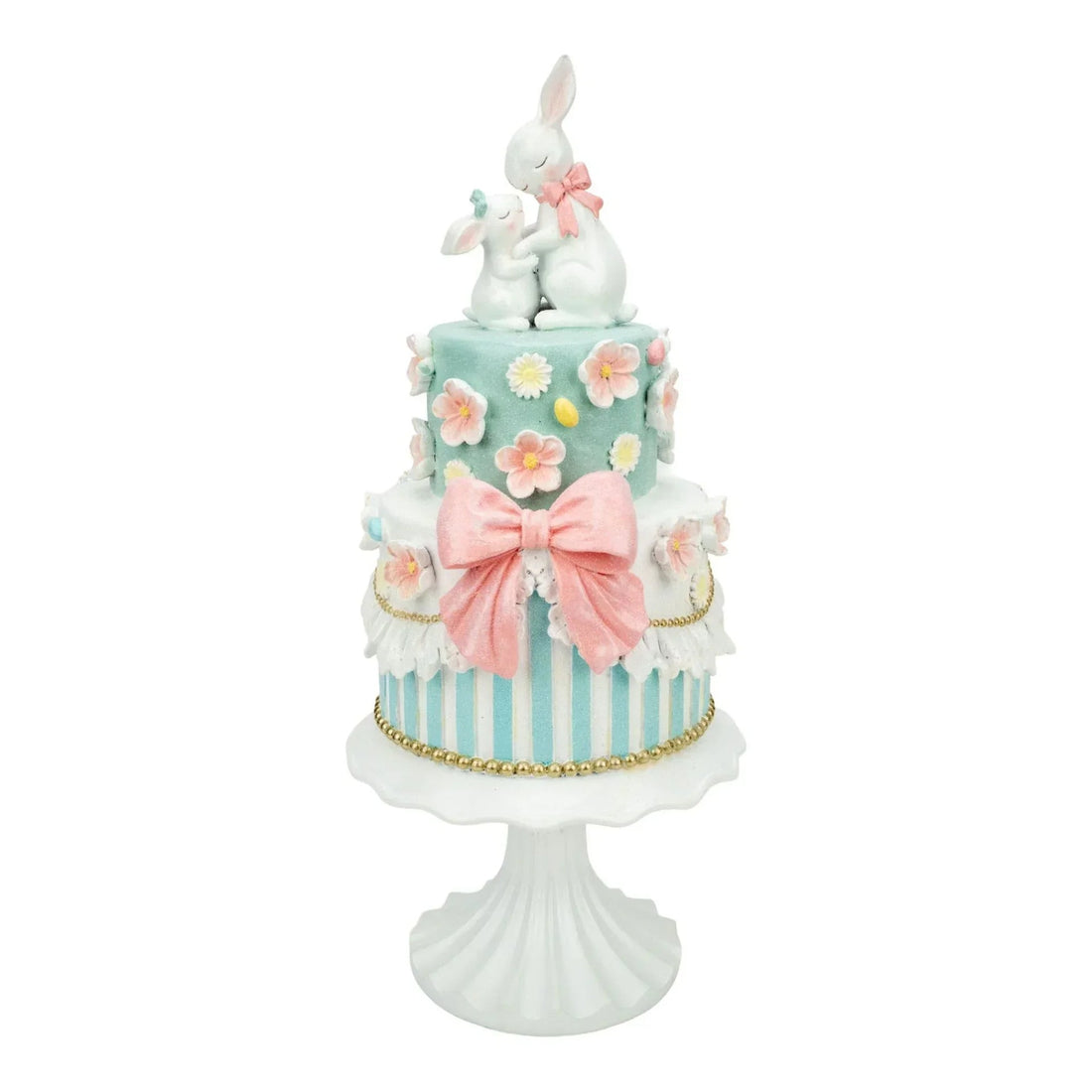 Easter bunny cake decoration with pastel flowers, pink bow, and striped tiers on white stand