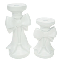 White ceramic angel candle holders with bow details, elegant home décor accents