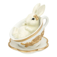 White bunny figurine in gold-trimmed teacup, elegant home décor accent with vintage charm