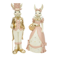 Elegant bunny figurines in pink and gold, dressed for Easter with top hat and egg basket, perfect home décor.
