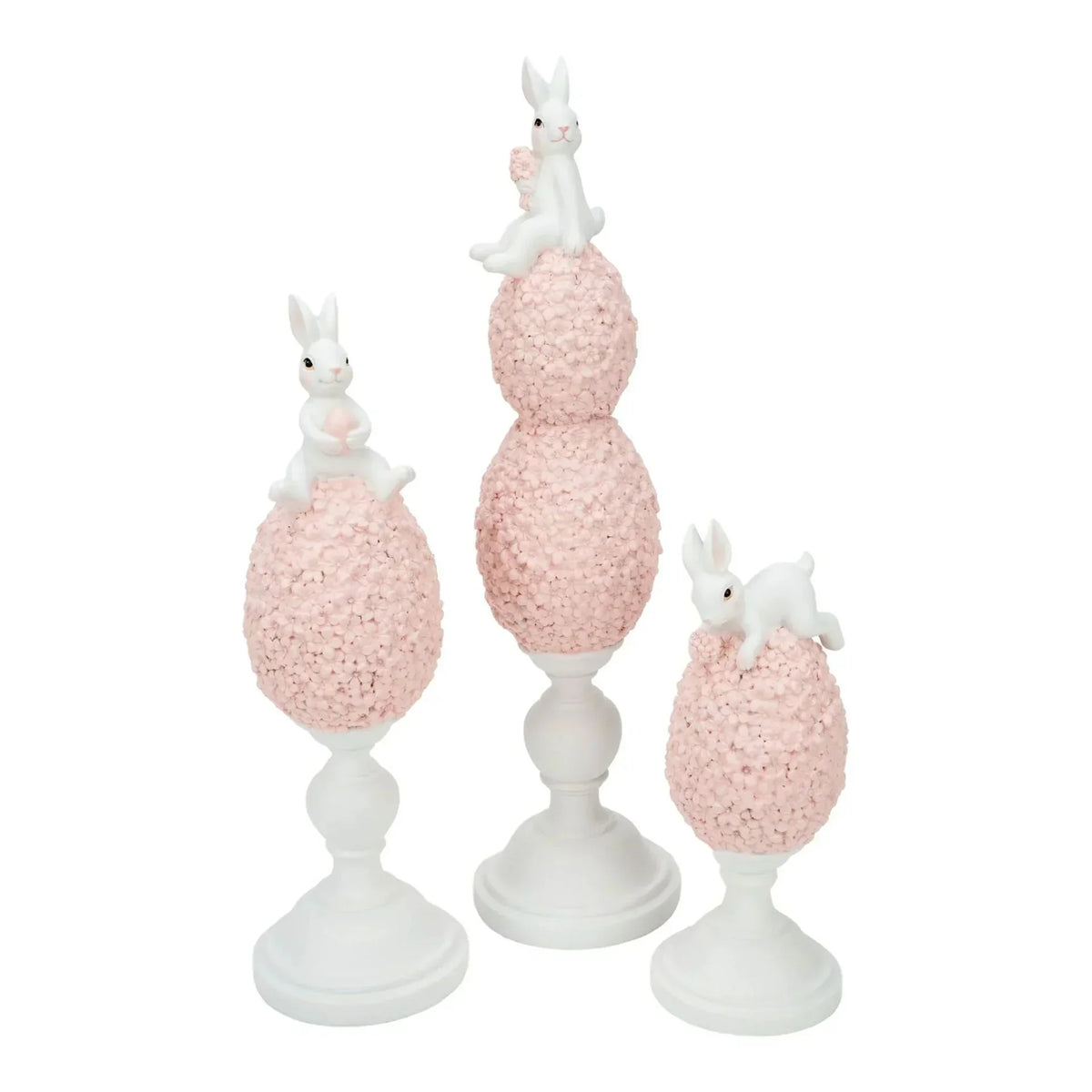 White bunny figurines atop pink floral egg pedestals, elegant home décor set