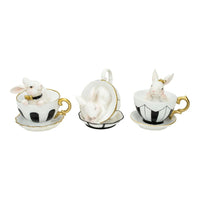 White bunny figurines in black and white teacups with gold trim, elegant home décor accents