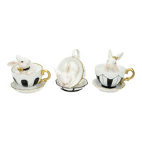 White bunny figurines in black and white teacups with gold trim, elegant home décor accents