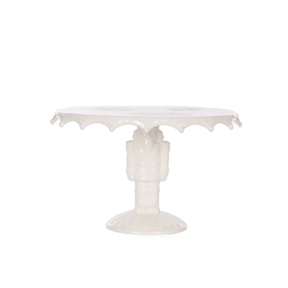 Elegant white ceramic cake stand with scalloped edge and ornate pedestal base, perfect for vintage home décor