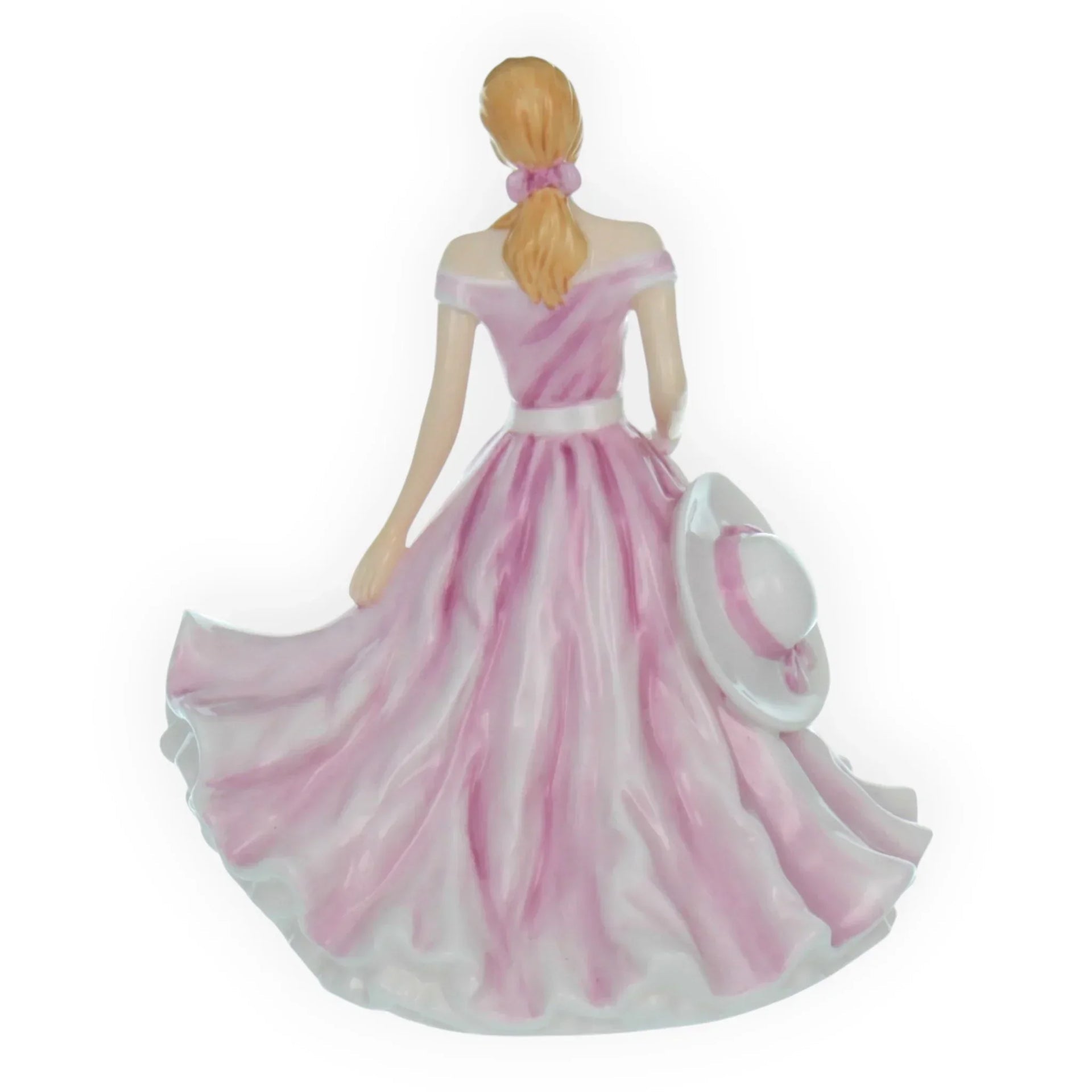 Elegant porcelain figurine of woman in pink gown holding hat, vintage home décor accent piece