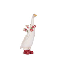 White goose figurine wearing red boots and festive scarf, holiday home decor