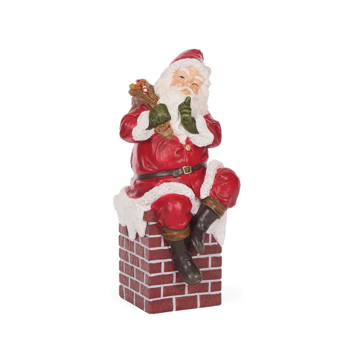 Santa Claus figurine perched on brick chimney, holding gifts, festive holiday decor
