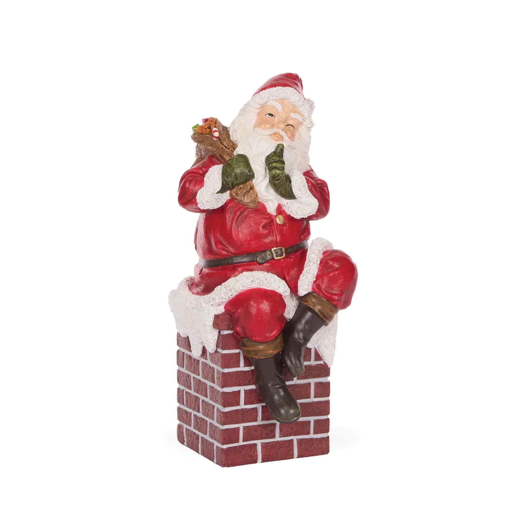 Santa Claus figurine perched on brick chimney, holding gifts, festive holiday decor