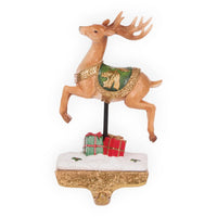 Vintage Christmas reindeer figurine with green gold saddle, gift boxes, snow base, festive holiday décor