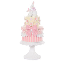 Pink and white tiered cake decor with bunnies, flowers, and bow for home décor