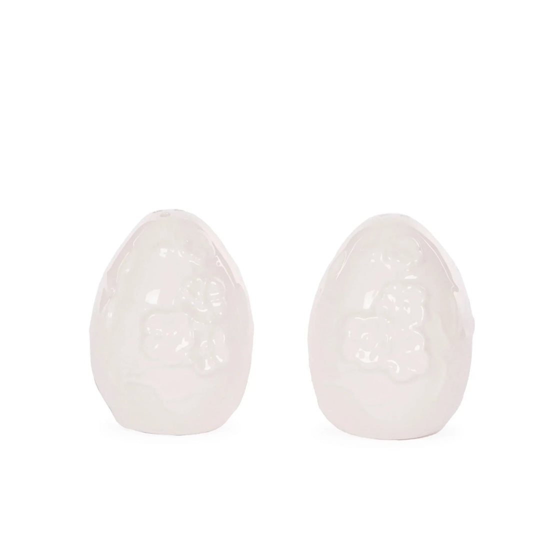 White ceramic egg-shaped ornaments with floral relief, elegant home décor accents