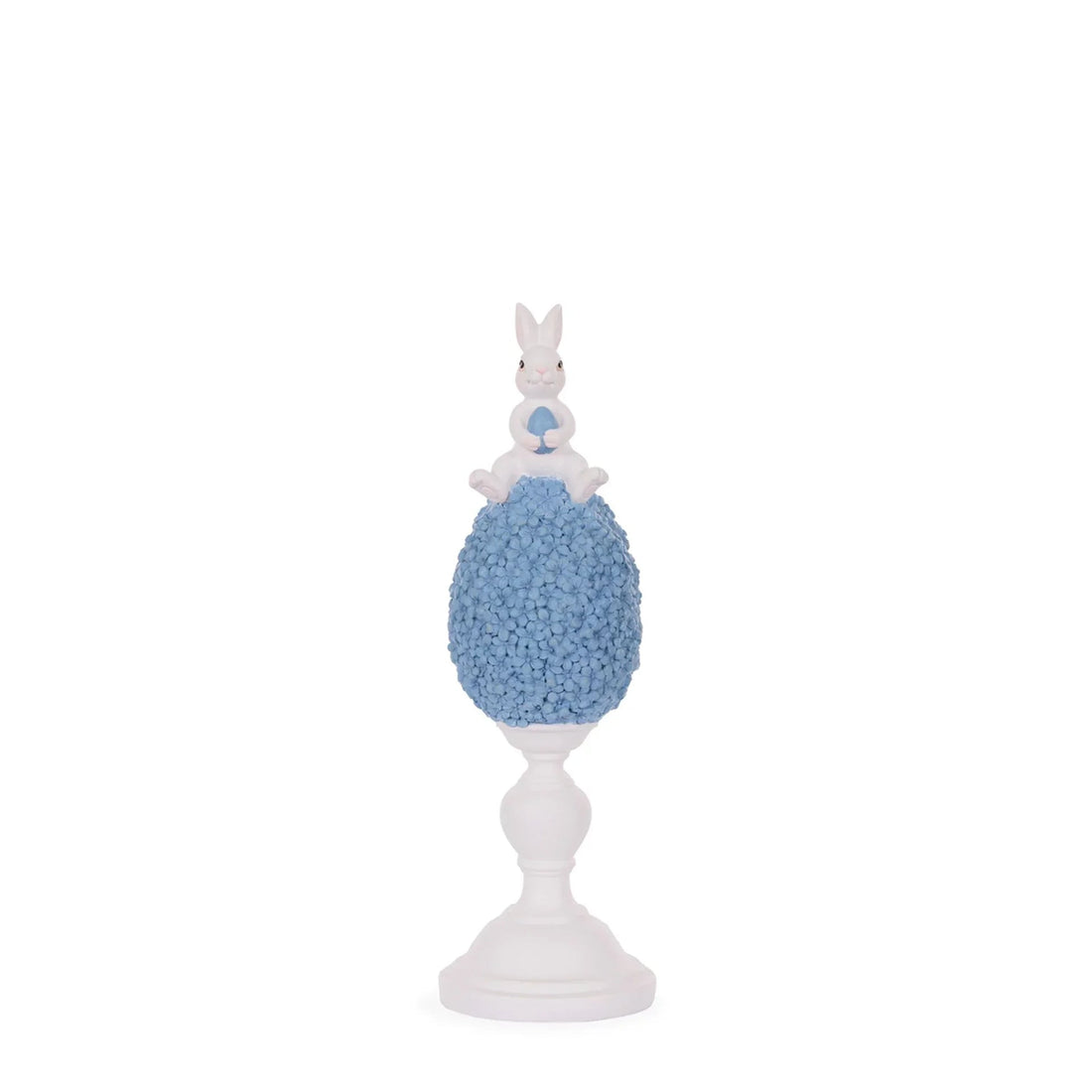 White bunny holding blue egg atop floral egg on pedestal, Easter home decor