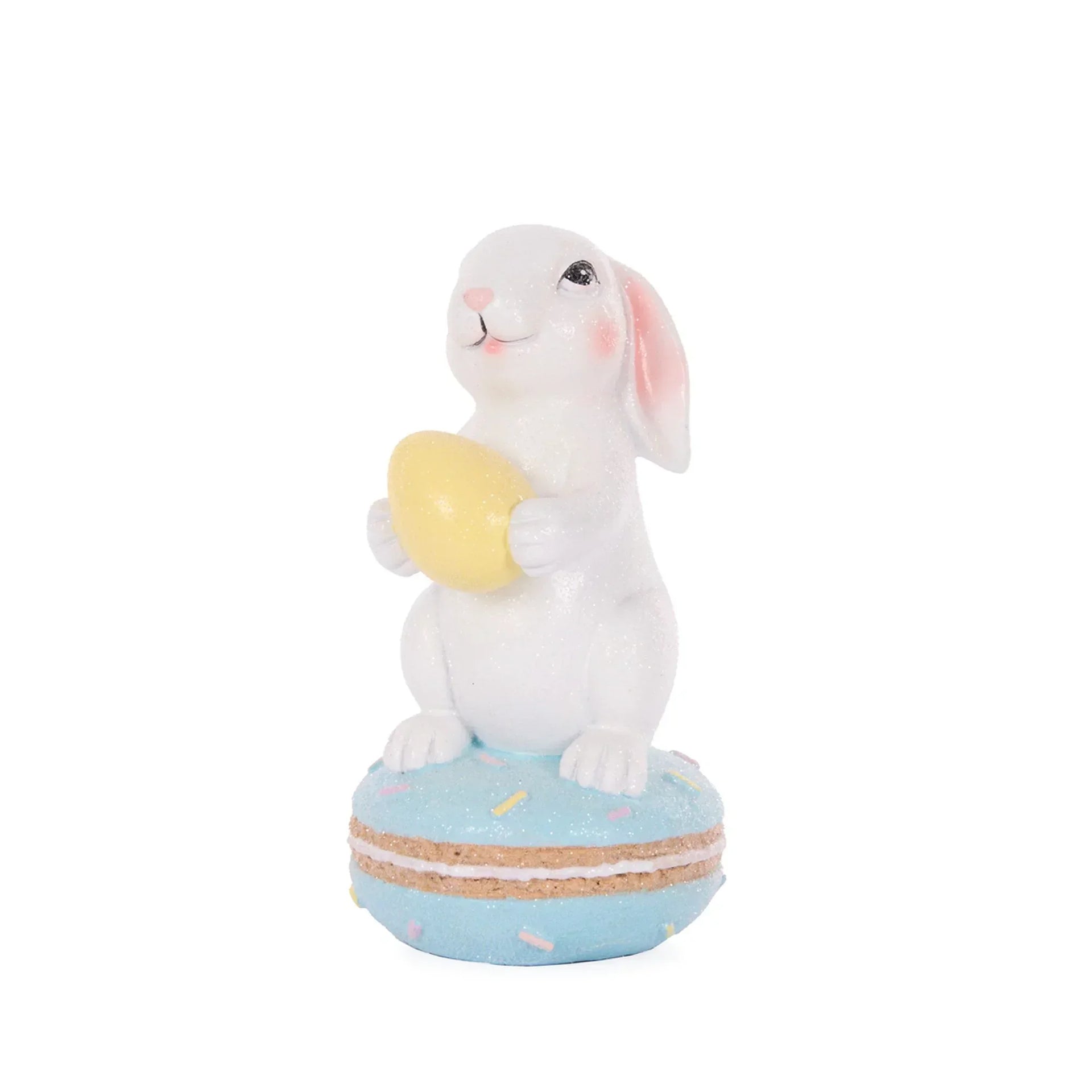 Glittery white bunny holding yellow egg, perched on blue macaron base – Easter home décor