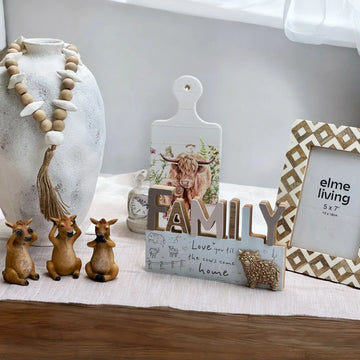 Decorative items including a vase, figurines, and a 'family' sign on a table.