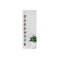 Rustic metal spiral wall hanging with leaf accents, perfect for vintage home décor and farmhouse style interiors.