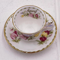 Elegant April floral teacup and saucer set with gold trim, vintage home décor