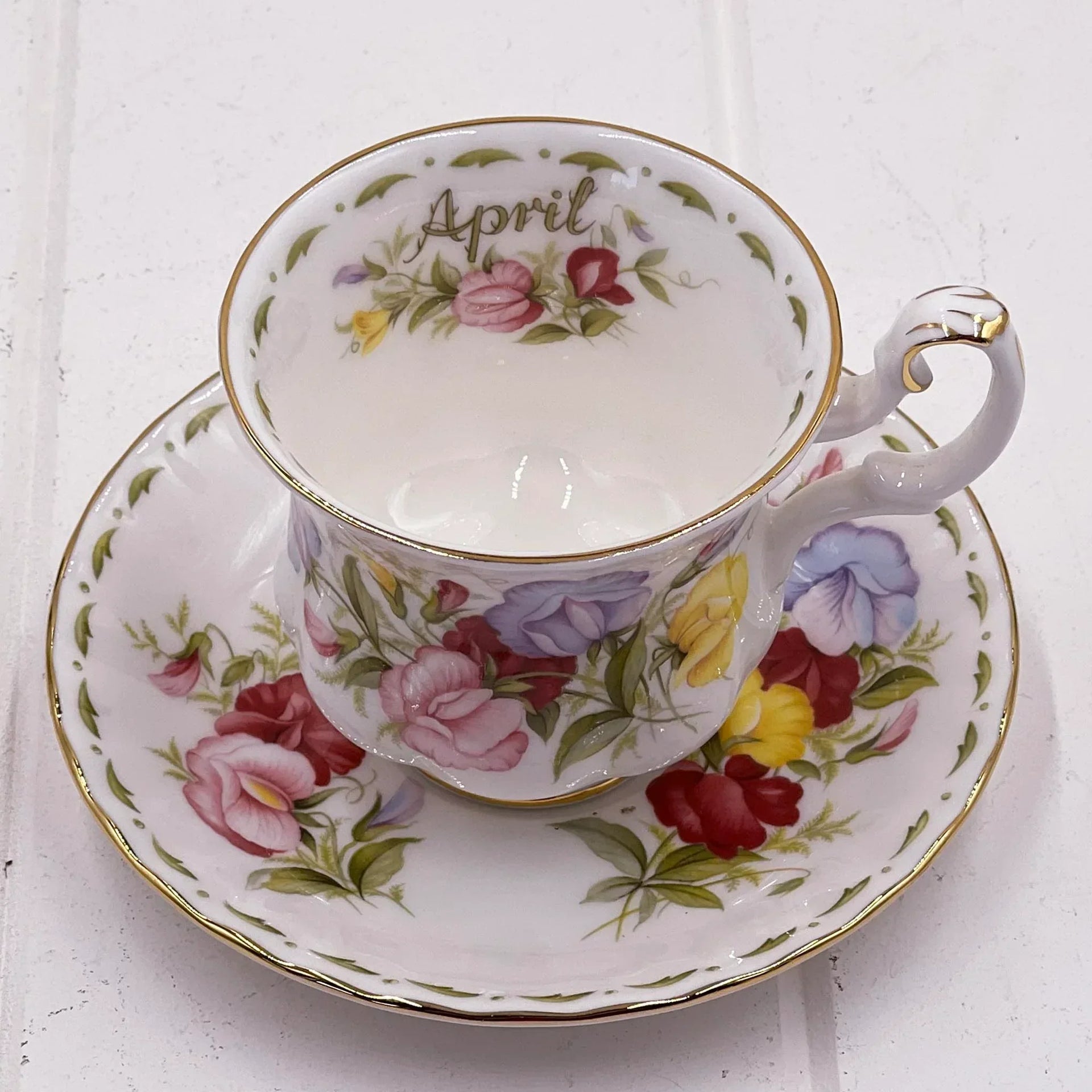 Elegant April floral teacup and saucer with gold trim, vintage-inspired home décor